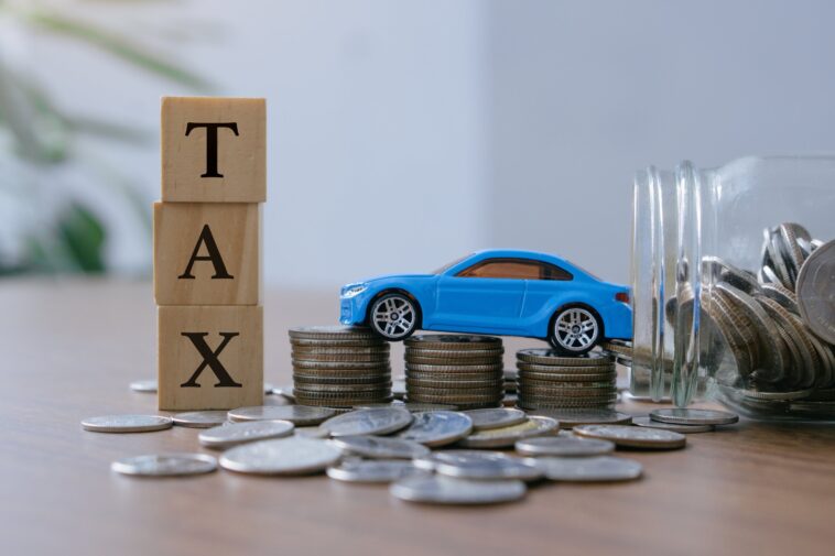 Car,Tax,Concept.close,Up,Stack,Of,Coins,And,Tax,Wooden